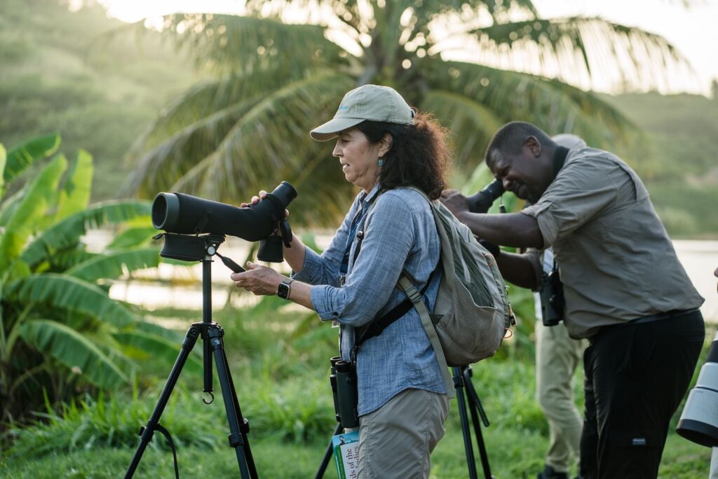 Behind-the-scenes image of a Caribbean creative directing a shoot with calm authority and refined style
