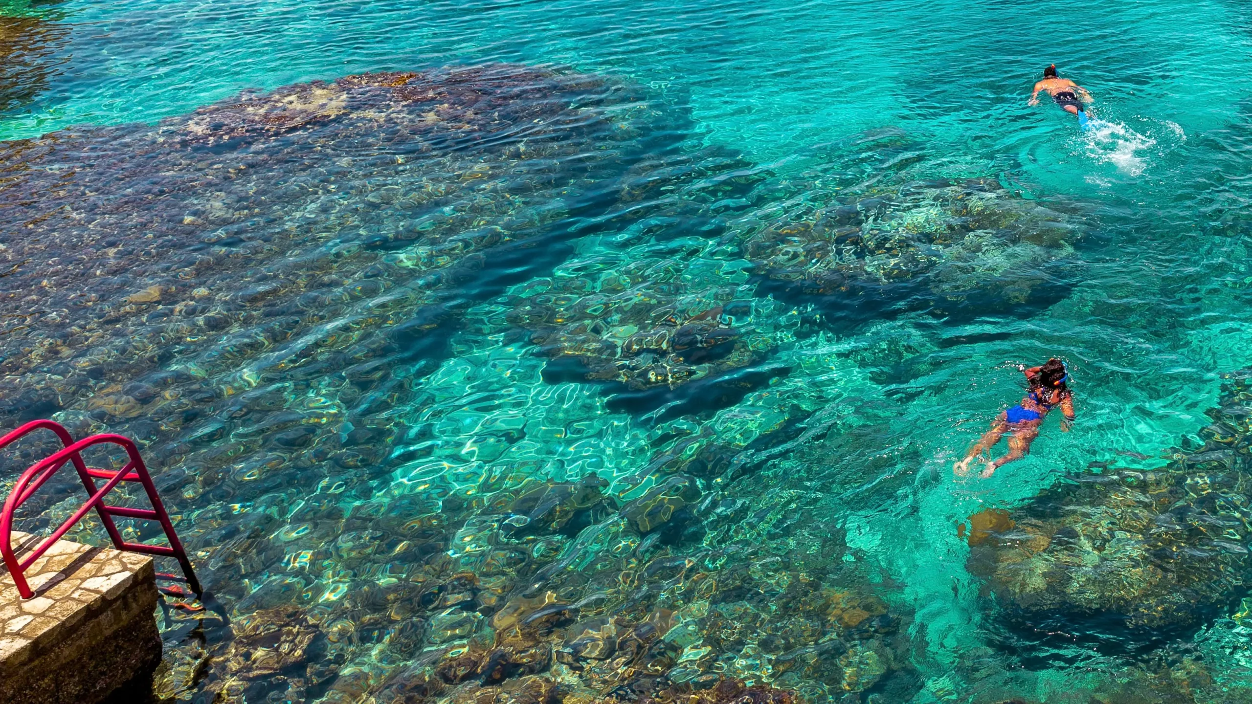 Person floating calmly in the ocean off Negril, Jamaica, using water as a natural form of reset and restoration