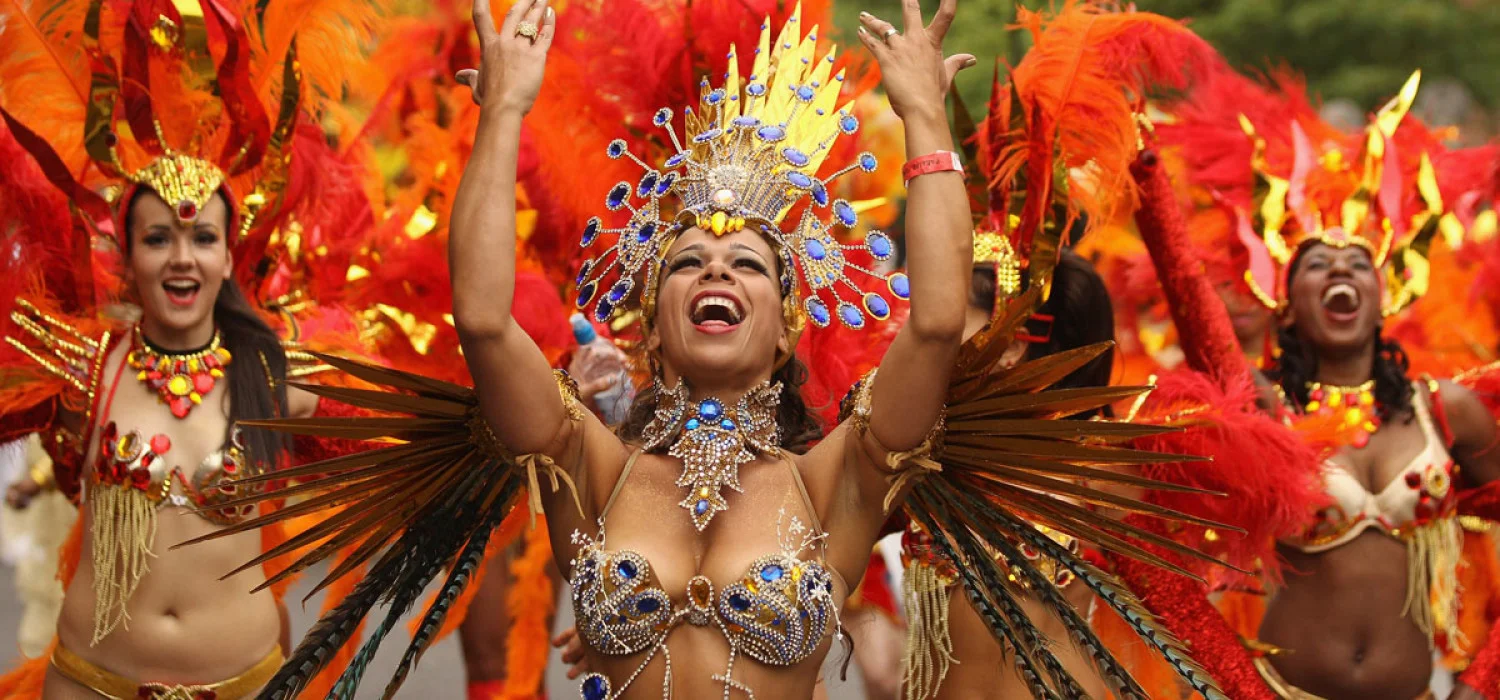 Masqueraders moving through the streets of Port of Spain during Trinidad Carnival road march, surrounded by music, sweat, and motion