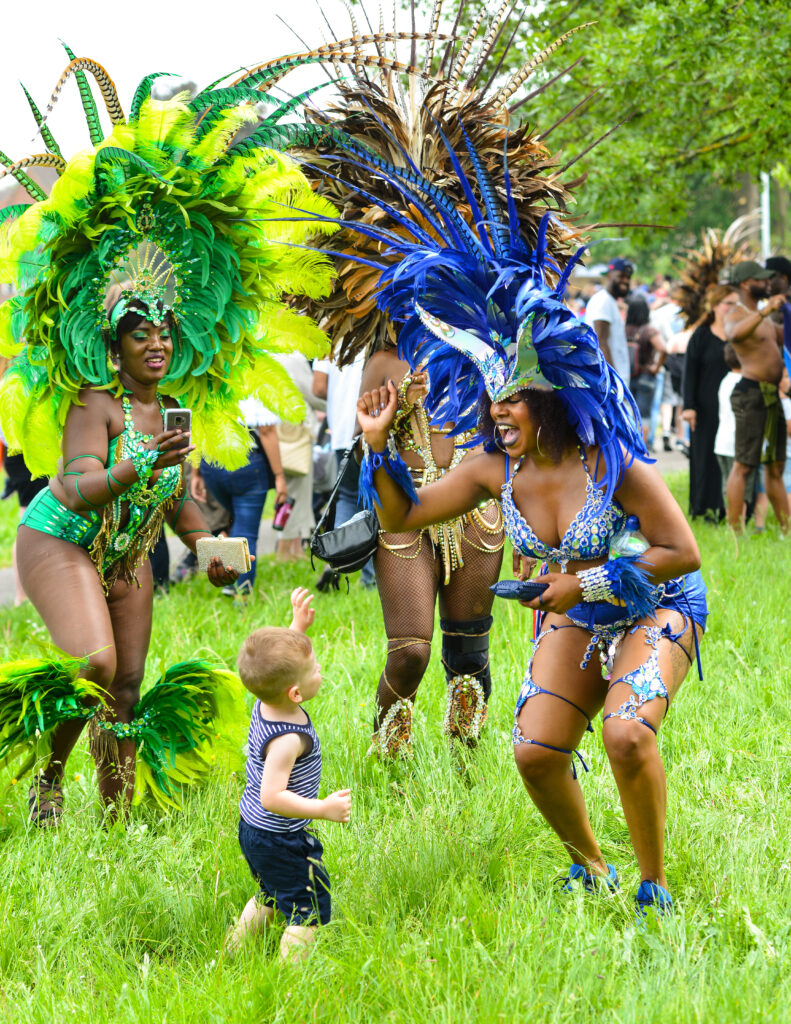 Masqueraders dancing while playing mas in Trinidad during Carnival Monday with a moving band