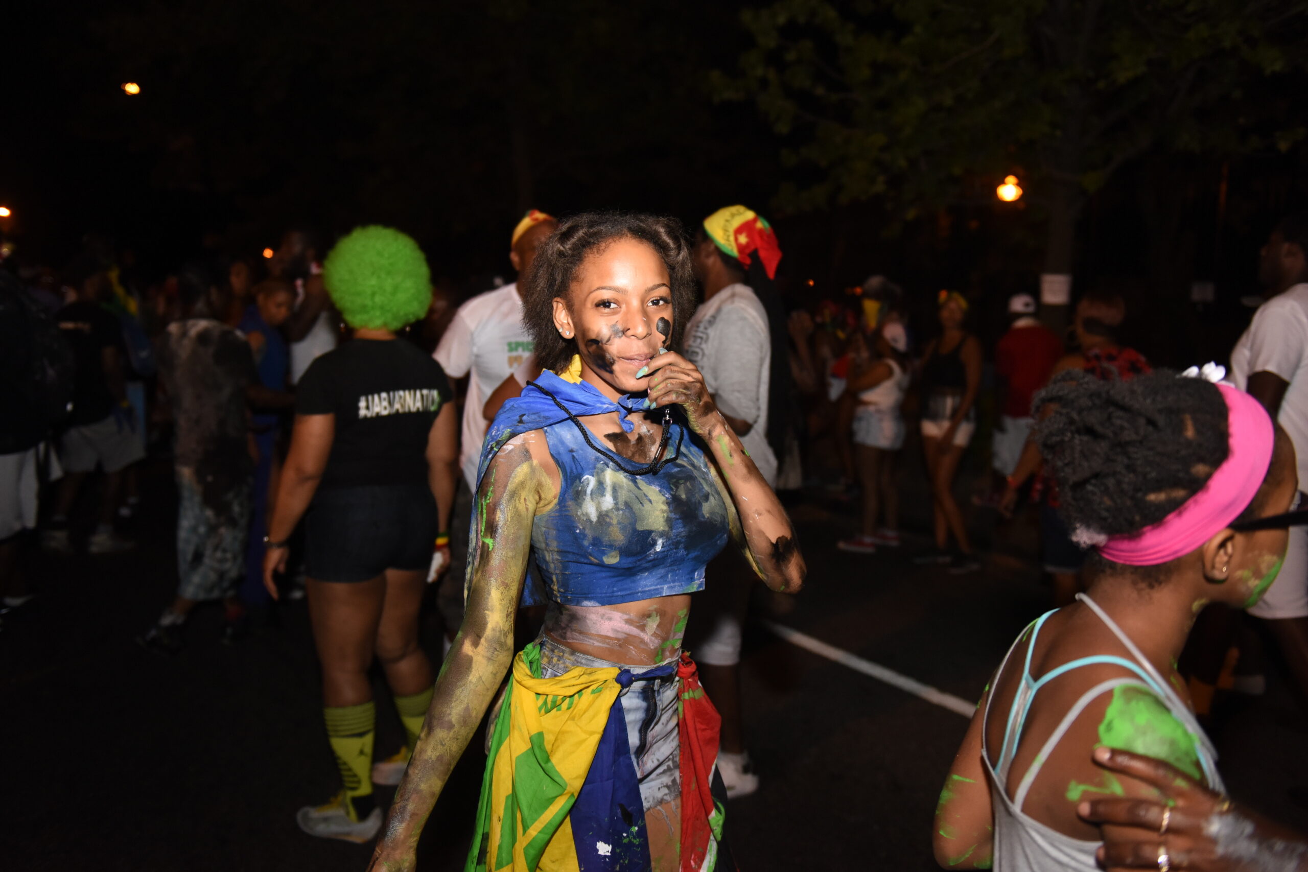 Participants covered in paint and mud celebrating J’ouvert in Port of Spain before sunrise