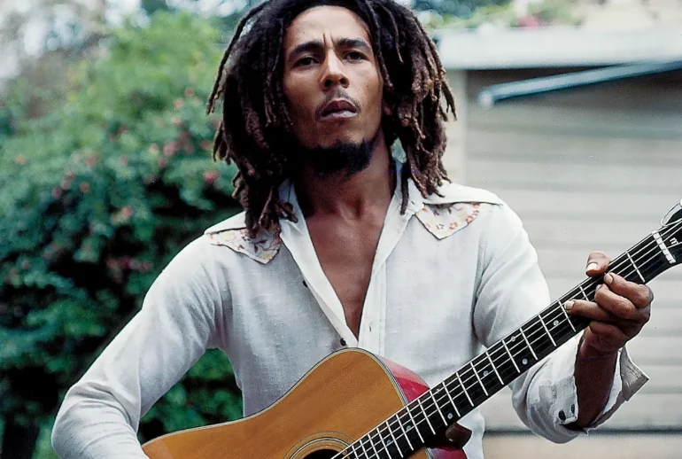 portrait of Bob Marley performing live, capturing his presence and stage authority