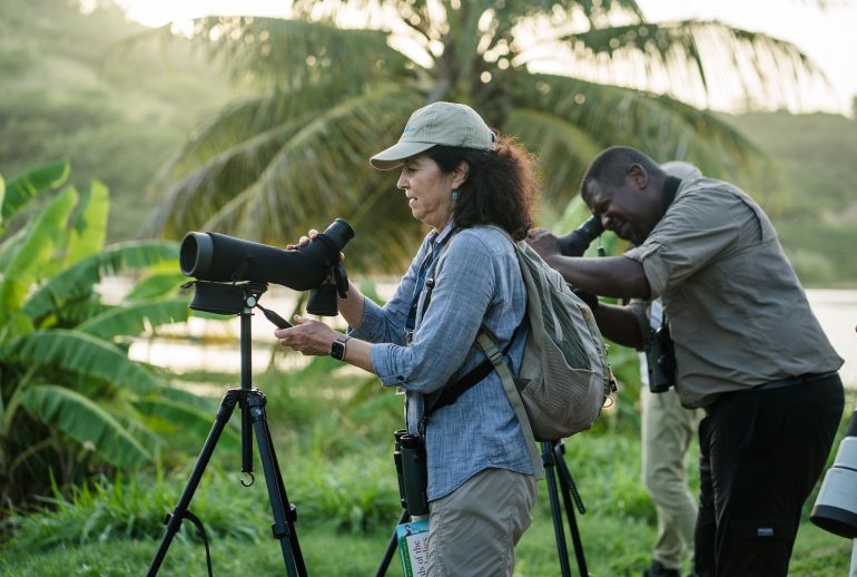 Behind-the-scenes image of a Caribbean creative directing a shoot with calm authority and refined style