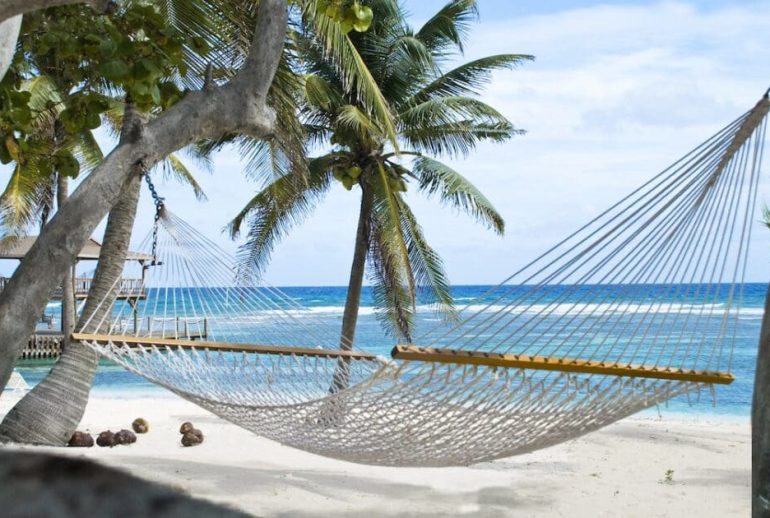 Serene Caribbean wellness scene with ocean horizon, natural materials, and a calm, restorative atmosphere