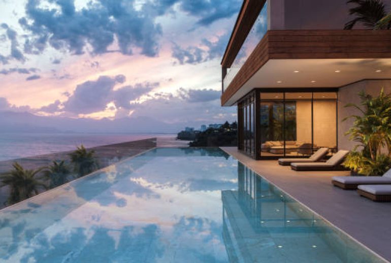 Understated luxury villa scene with natural textures, ocean light, and a sense of privacy and calm