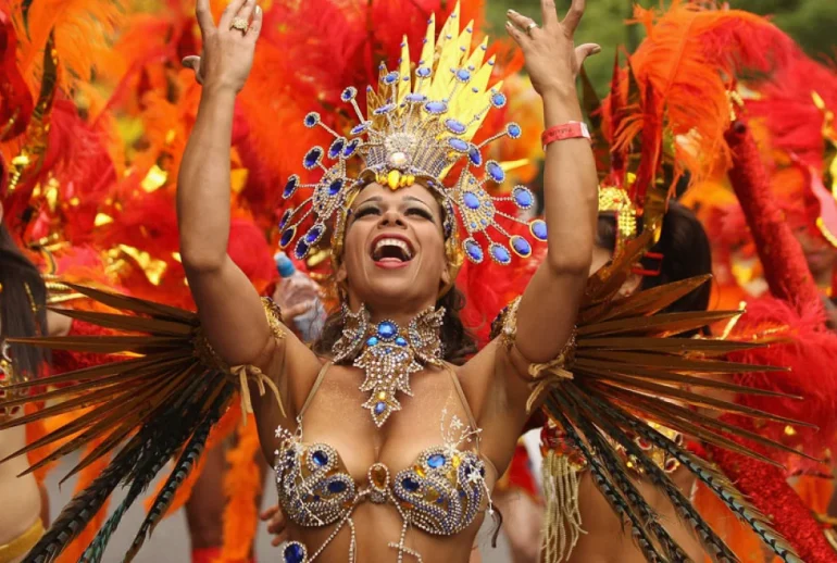 Masqueraders moving through the streets of Port of Spain during Trinidad Carnival road march, surrounded by music, sweat, and motion