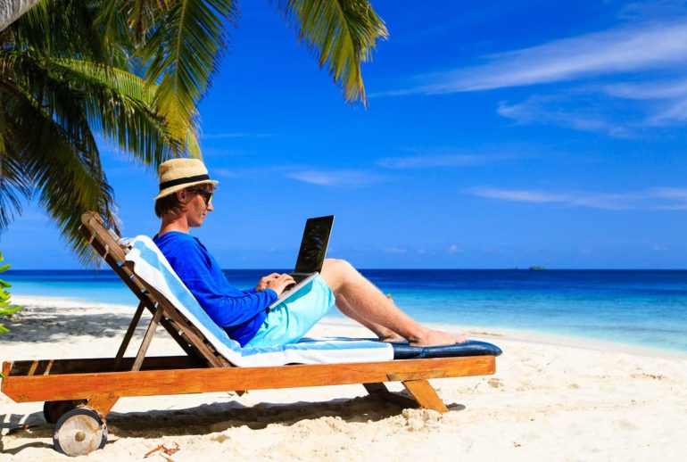 Modern Caribbean lifestyle scene of someone working remotely in a bright coastal setting